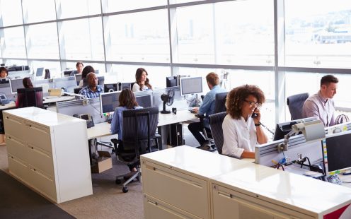 Casually dressed workers in a busy open plan office