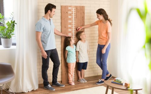 Parents measuring children's height
