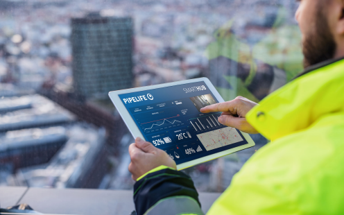 Facility manager holding a tablet with a report from Smart Pumping Stations on the screen | Pipelife