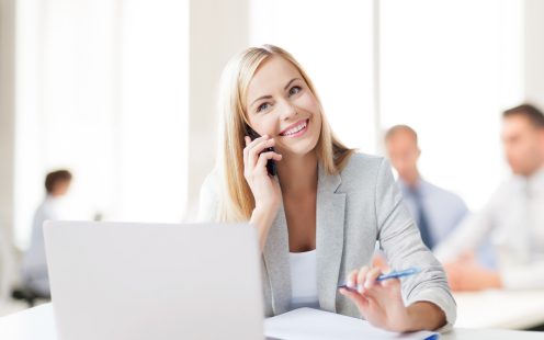 business concept - businesswoman talking on the phone in office